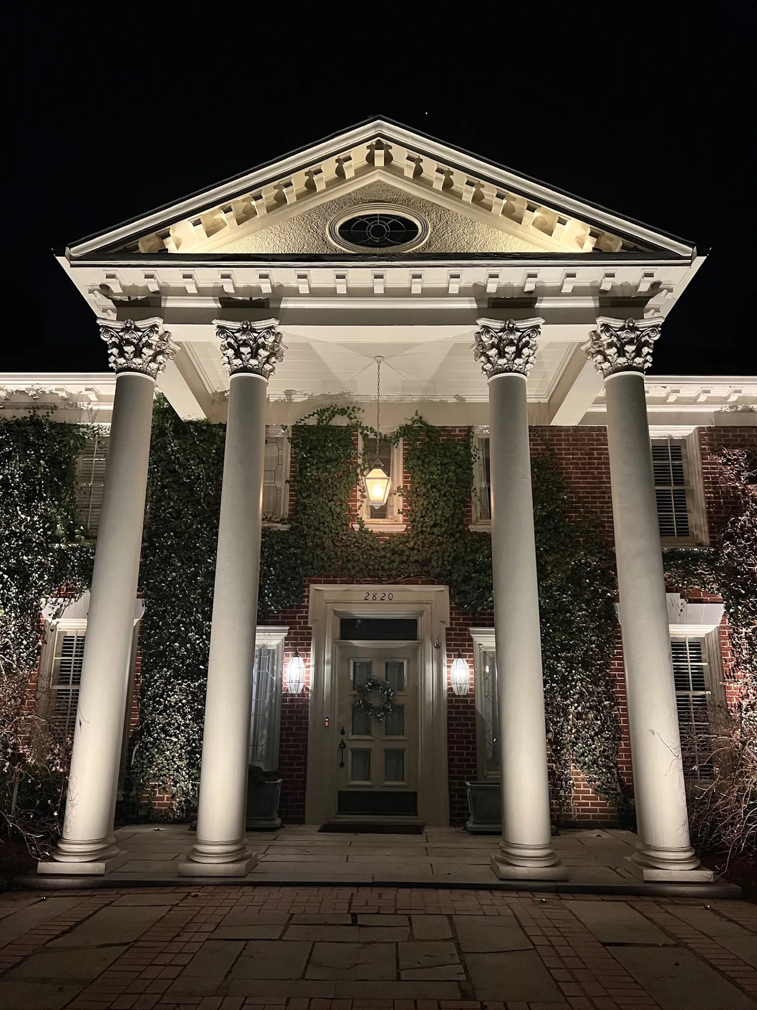 Portico columns lit from below. Landscape Lighting by LIT Outdoor Lighting in Tulsa.