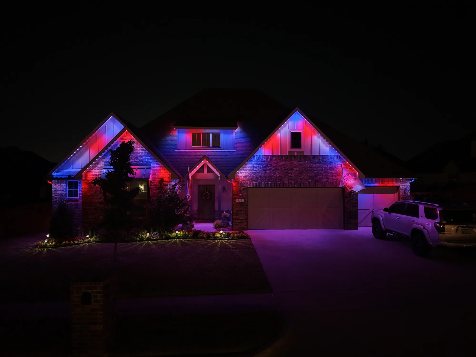 Gables outlined in red and blue. Permanent Lighting by LIT Outdoor Lighting in Tulsa.