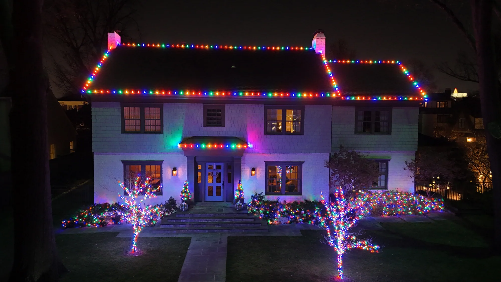 Rainbow roofline with trees to match. Christmas Lighting by LIT Outdoor Lighting in Tulsa.