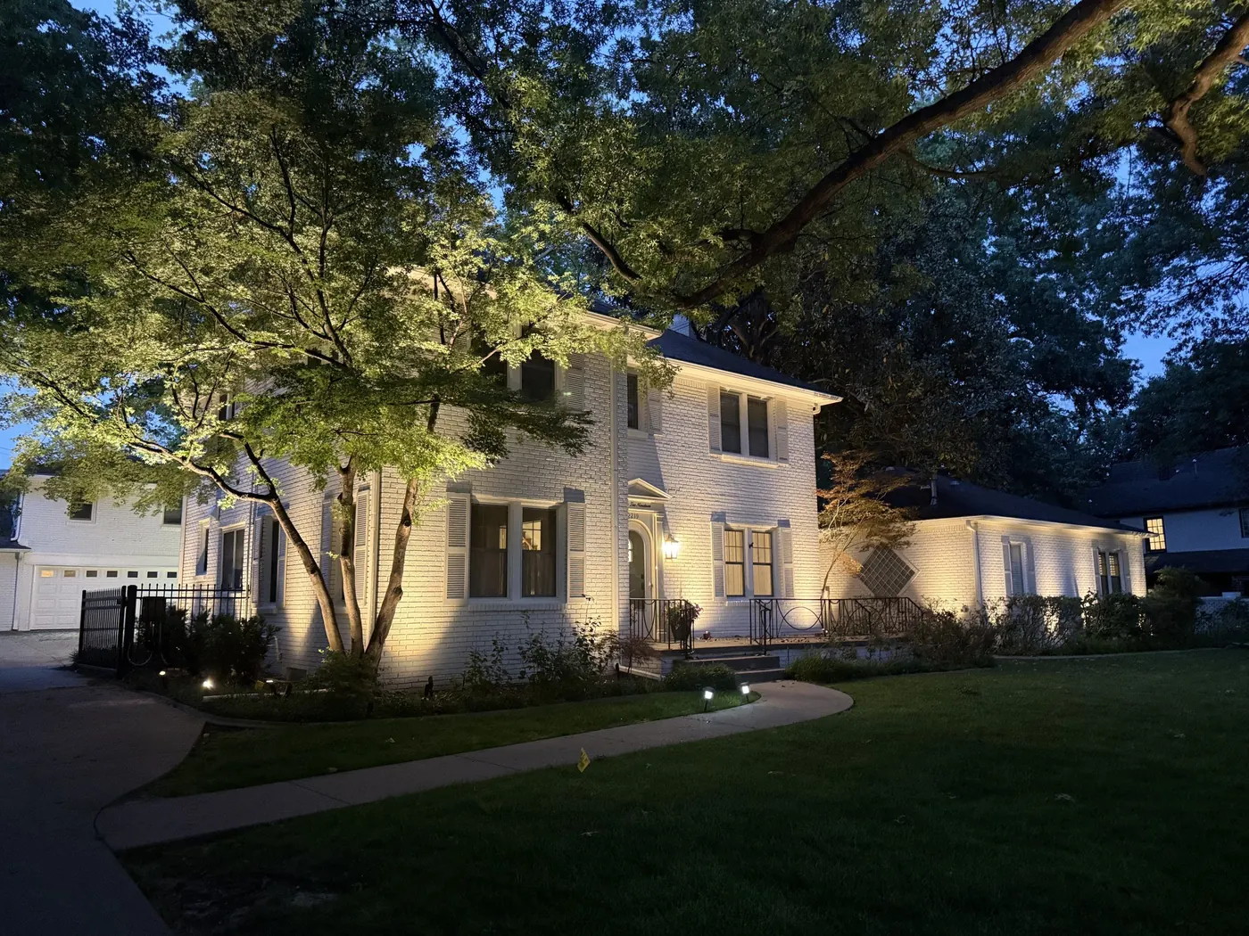 White brick two story, washed and uplit