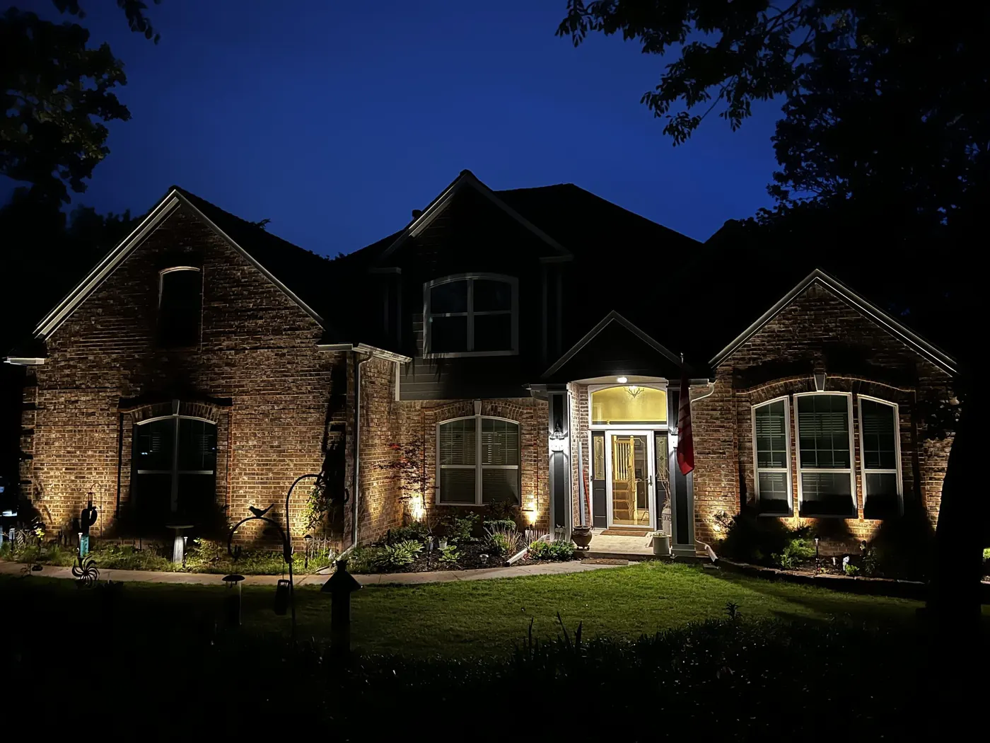 Brick home with the gables picked out. Landscape Lighting by LIT Outdoor Lighting in Tulsa.
